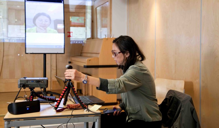 Jingru Høivik, Chief Engineer at the National Library of Norway, preparing to use Skype at a seminar with external specialists and Norad advisors. 