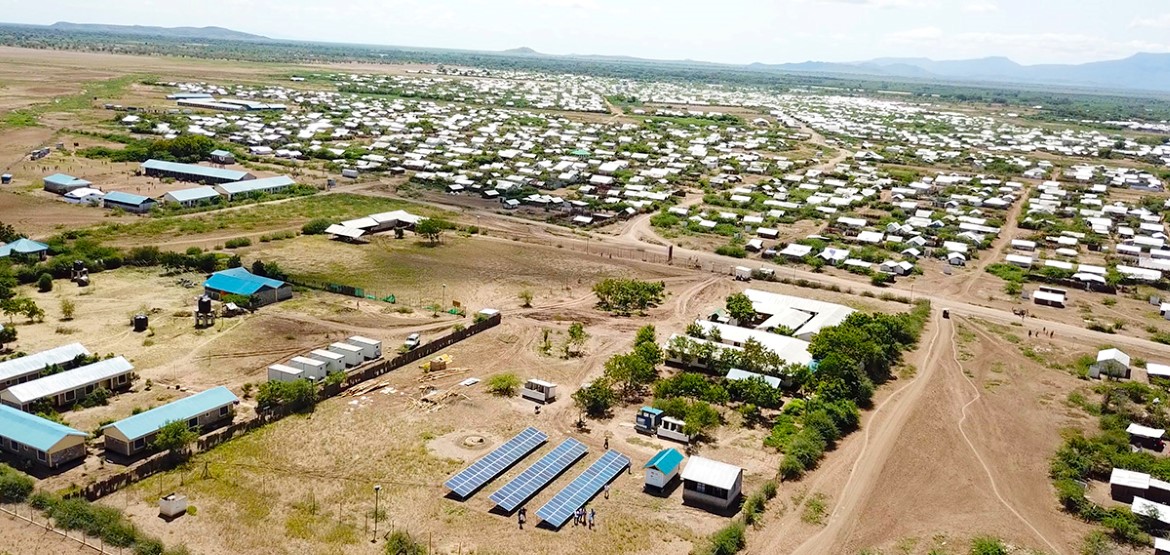Photo of refugee camp and solar panels