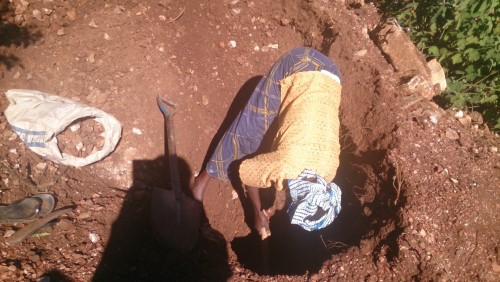 Female digging stones for the search of gold