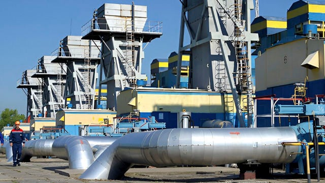 Outdoor image of an industrial facility in metal in gray, yellow, and blue.