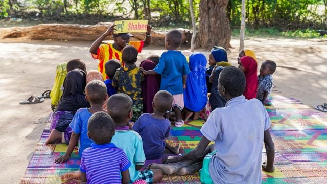School kids sitting together outside